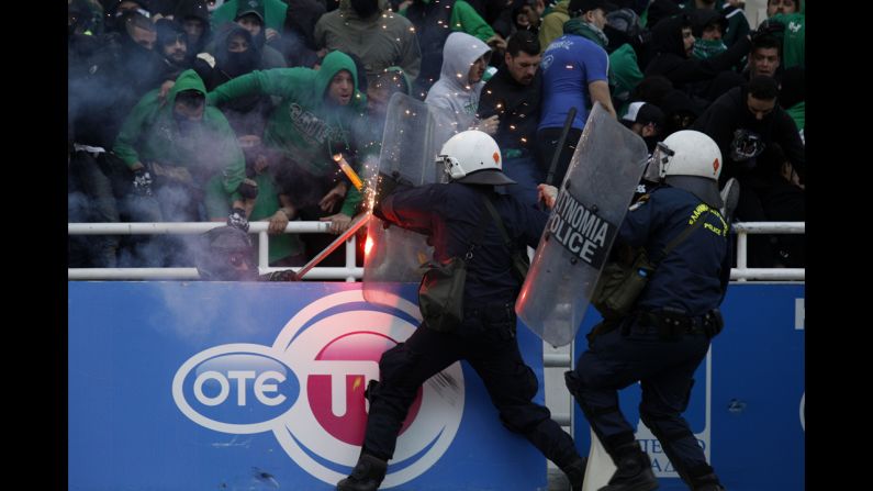 Riot police clash with soccer fans at the Olympic Stadium in Athens, Greece, prior to the Greek Cup final between Panathinaikos and PAOK on Saturday, April 26. Panathinaikos won the game 4-1.