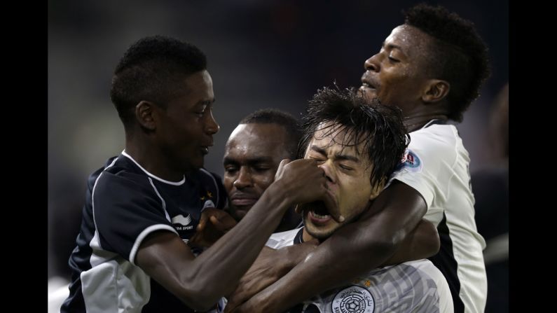 Players with the Qatari soccer team Al-Sadd celebrate after scoring a goal against Al-Ahli during an AFC Champions League match in Doha, Qatar, on Tuesday, April 22. Al-Sadd won the game 2-1 to advance to the knockout stage of the tournament.