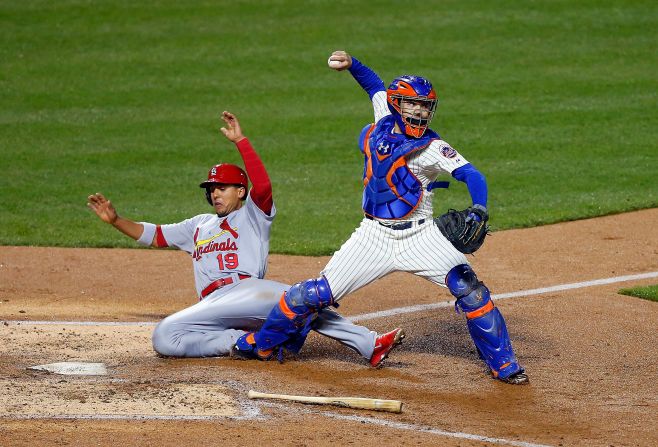 Jon Jay of the St. Louis Cardinals slides into Travis d'Arnaud of the New York Mets as d'Arnoud attempts a double play Tuesday, April 22, in New York. The Cardinals won the game 3-0.