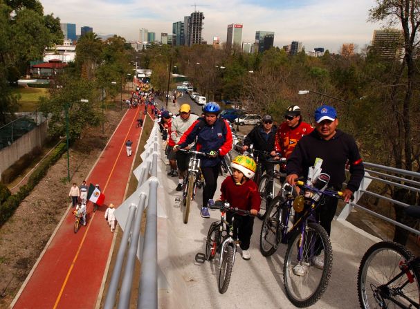 Government programs that encourage bike-riding and limit the number of days motorists can take to the streets have improved the city's serious pollution problem, longtime residents say.