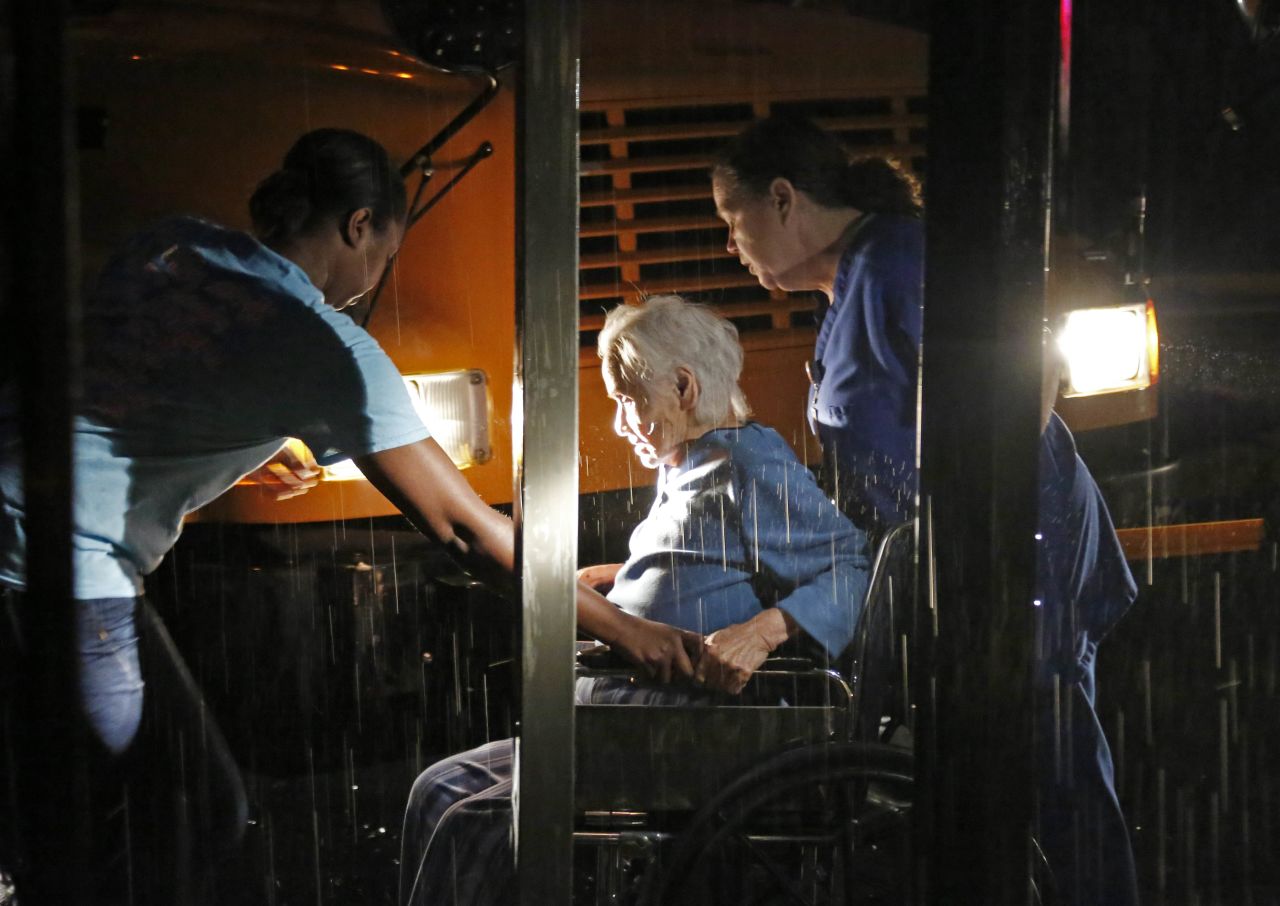Workers assist a resident in Louisville on April 28. A nursing home and the Winston Medical Center, Louisville's major hospital, were among the buildings hit.