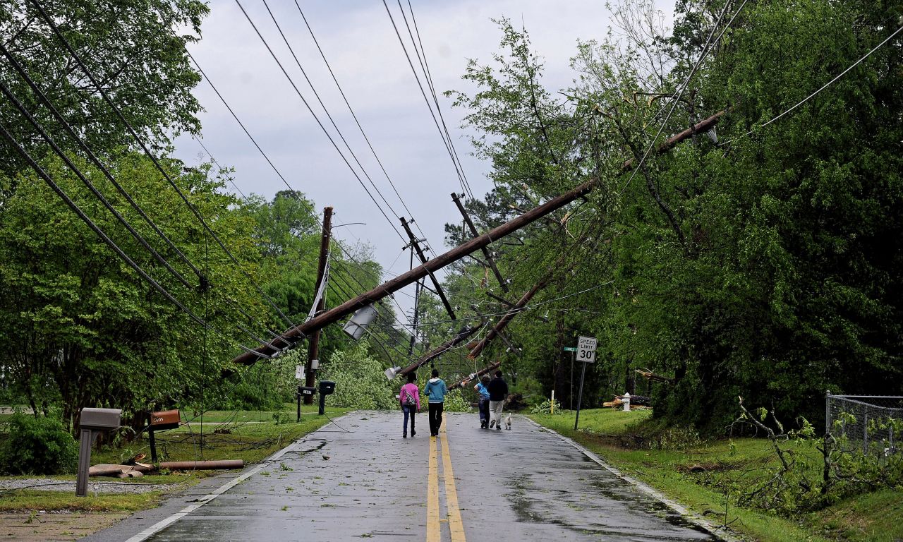 Residents walk along a Tupelo street on April 28.