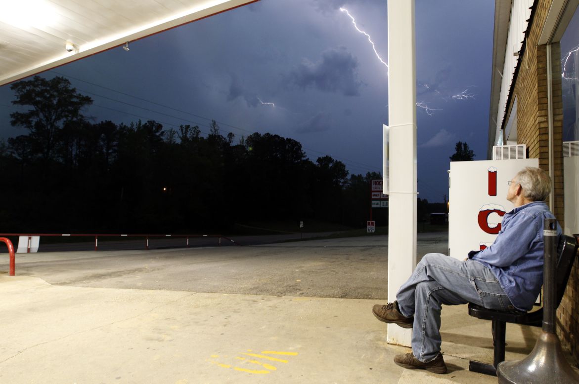 Jimmy Sullinger watches lightning as a storm approaches the gas station where he works in Berry, Alabama, on April 28. Alabama Gov. Robert Bentley declared a state of emergency for all counties.