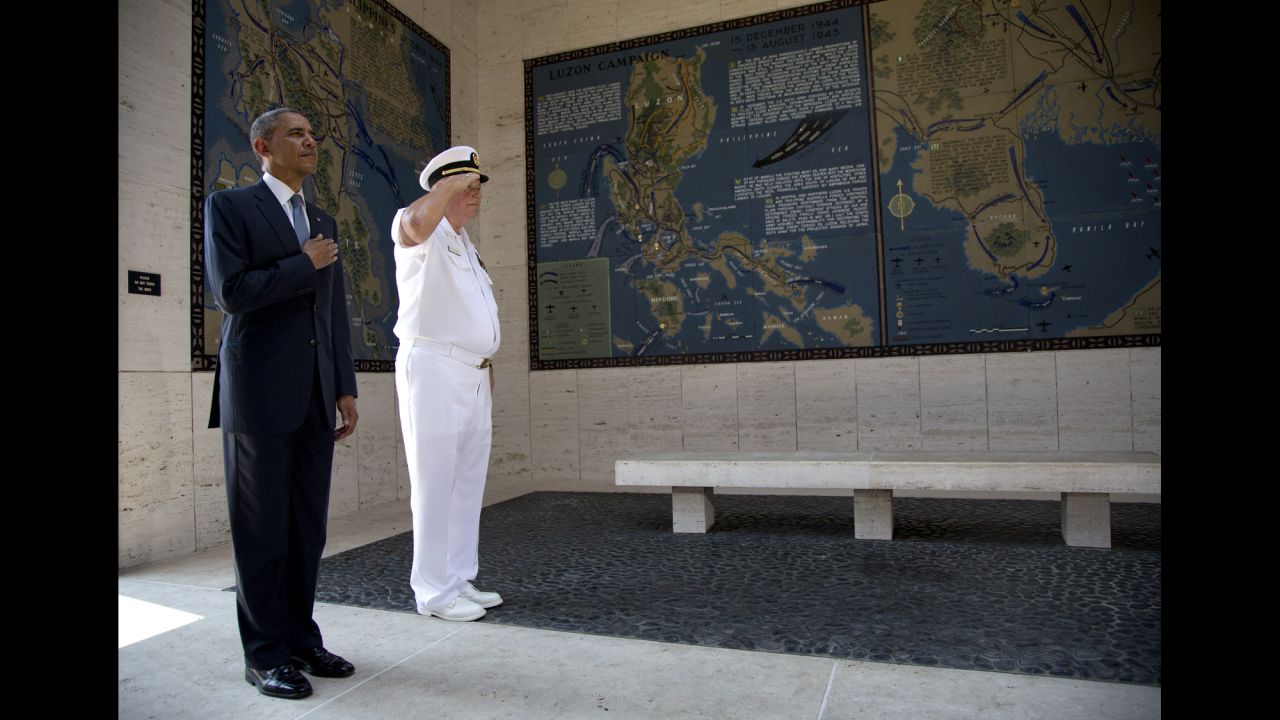 Obama holds his hand over his heart as he participates in a wreath-laying ceremony with Larry Adkison, the superintendent of the Manila American Cemetery and Memorial, at Fort Bonifacio on April 29.