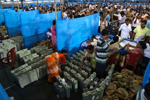 Election officials distribute electronic voting machines and other material to polling officials in Howrah, India, on Tuesday, April 29.