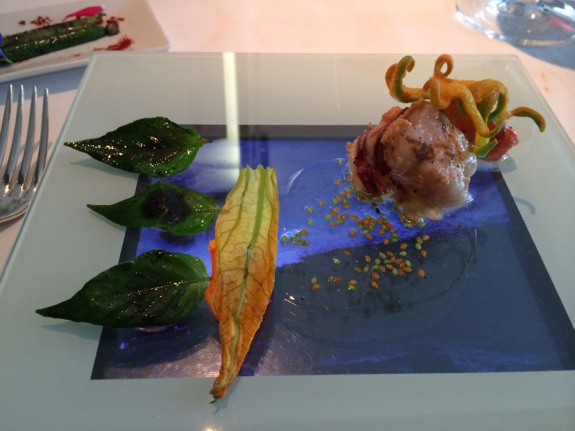 At Arzak, entrees are served on a translucent plate over an iPad. The lobster is accompanied by a video of waves crashing into shore, while burgers are served over a video of a flickering grill.