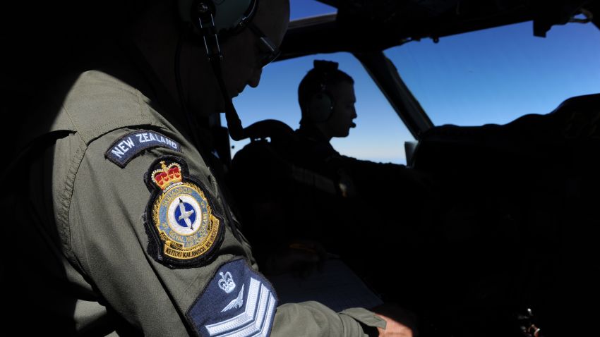 Pilot and aircraft captain, Flight Lieutenant Timothy McAlevey (R), with flight engineer Chris Poole (L), of the Royal New Zealand Airforce (RNZAF) P-3K2-Orion aircraft, flies his plane during the search for missing Malaysia Airlines flight MH370 in flight over the Indian Ocean on April 13, 2014 off the coast of Perth, Australia.