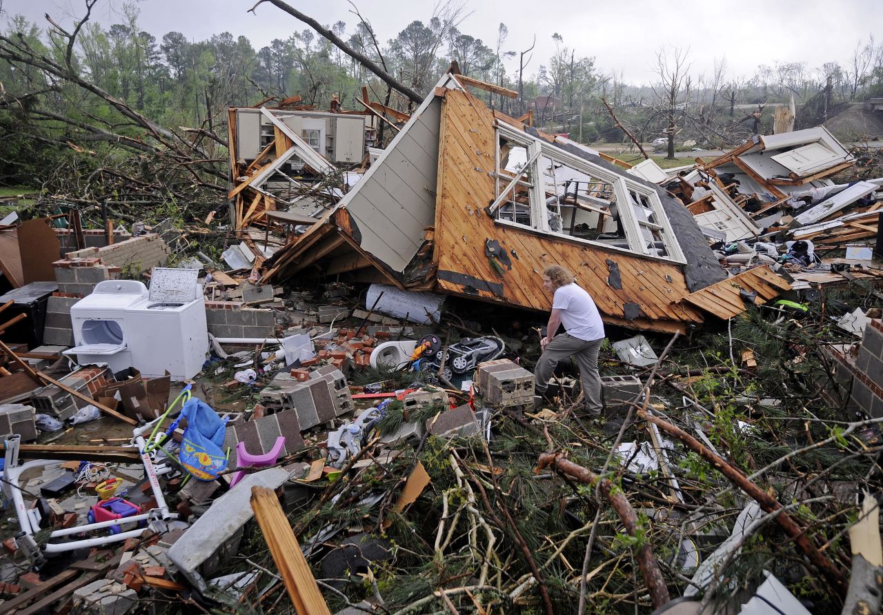 Kevin Barnes searches the remains of his home in Tupelo on April 29.