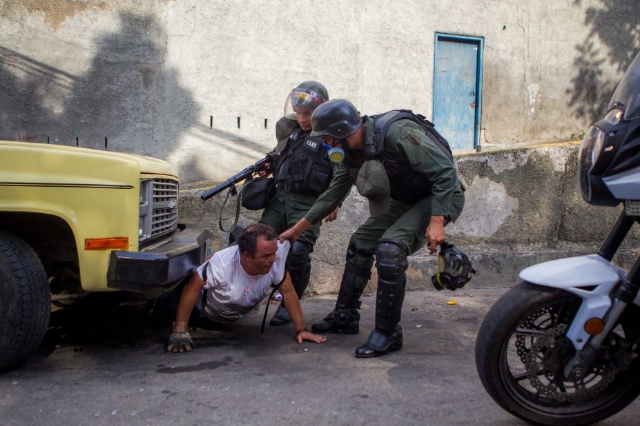Members of the Venezuelan National Guard detain a man during a protest against the government of President Nicolas Maduro in Caracas, Venezuela, on Saturday, April 26. Over several months, protesters unhappy with Venezuela's economy and rising crime have squared off against security forces.