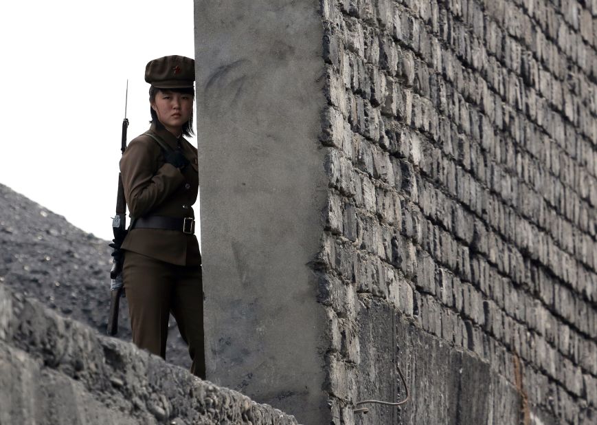 A North Korean soldier patrols the bank of the Yalu River, which separates the North Korean town of Sinuiju from the Chinese border town of Dandong, on Saturday, April 26.