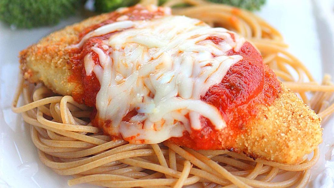 Baked chicken, whole wheat pasta and a side of veggies make for a healthy chicken parmesan.