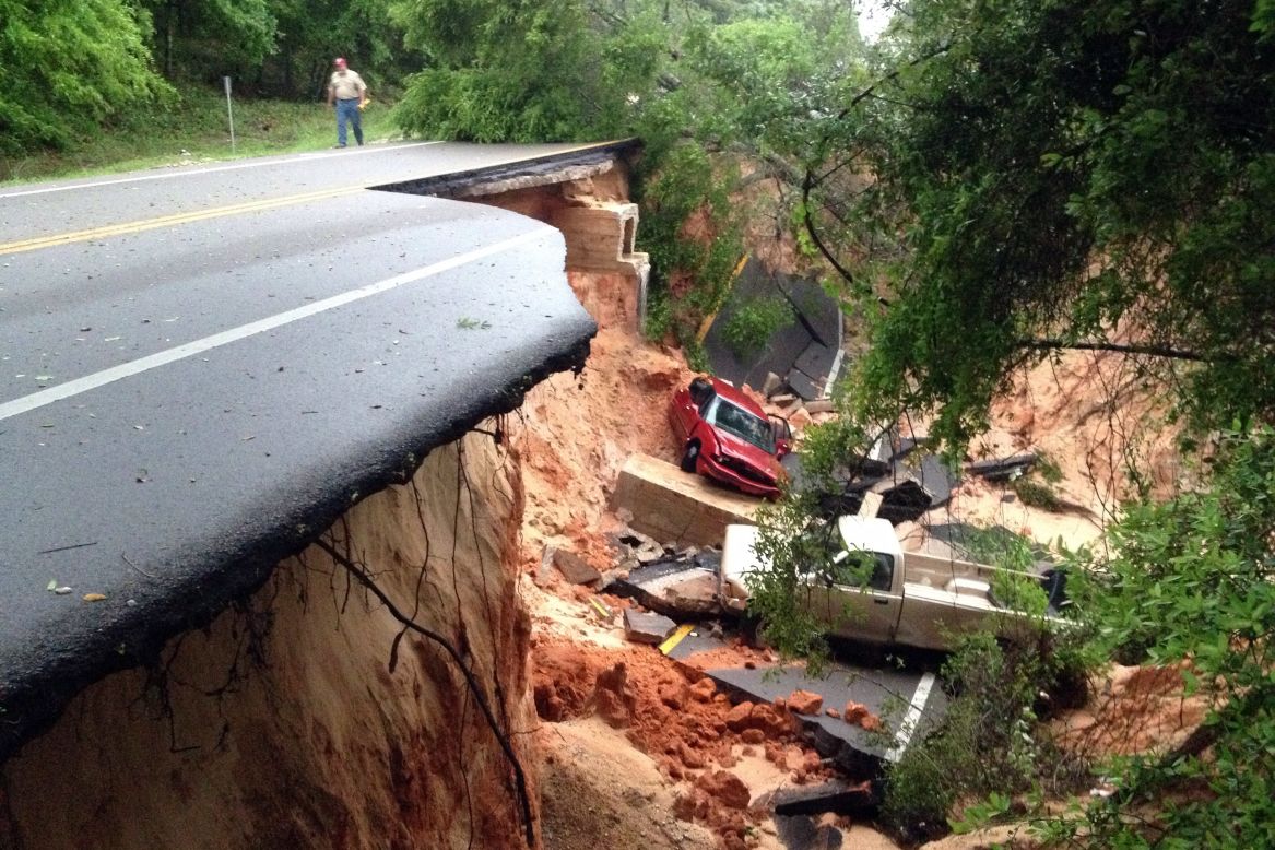 On Florida's Gulf Coast, torrential rains reduced some streets to rubble, gouged huge gashes in others and left stretches of others submerged. Here, vehicles rest at the bottom of a ravine after part of the Scenic Highway collapsed near Pensacola, Florida, on April 30. 