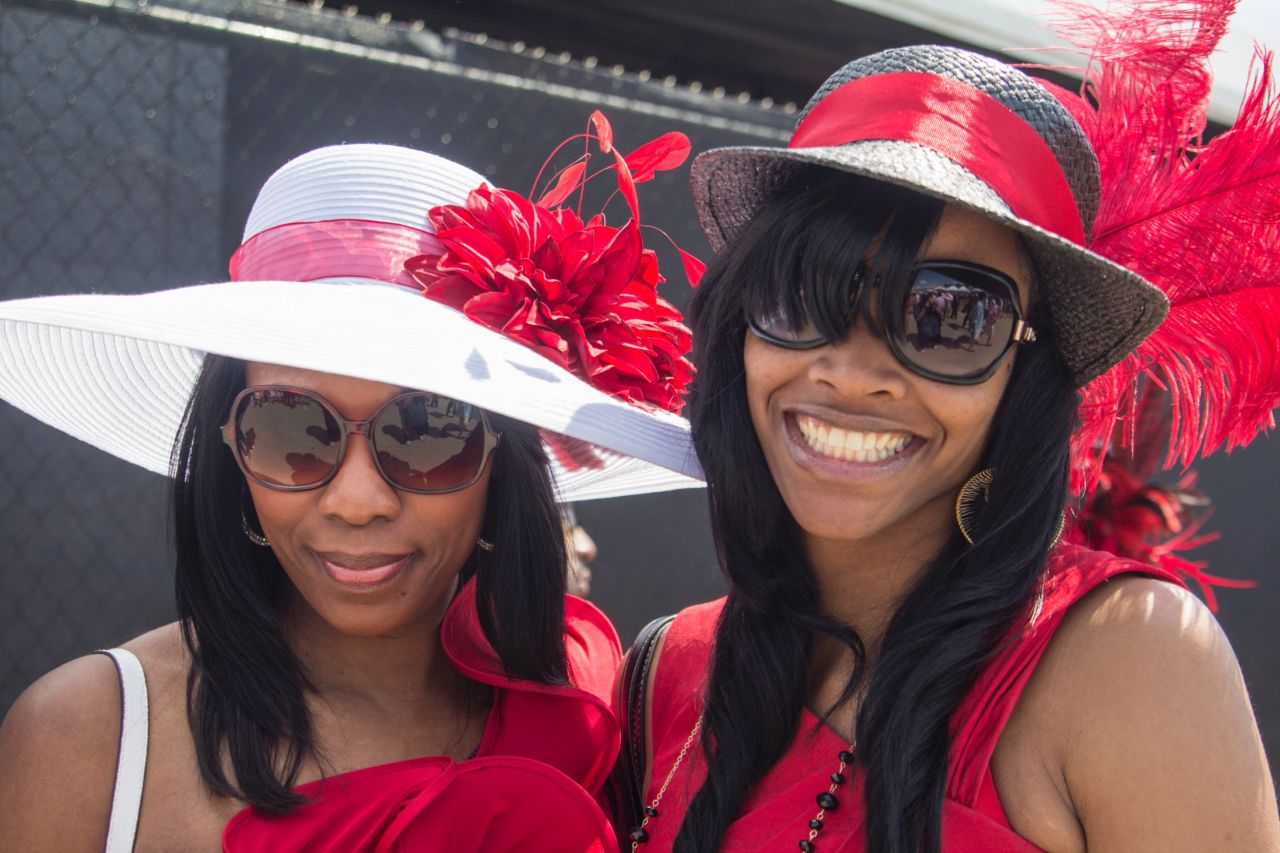 Big glasses, big hats and big smiles. The derby is also referred to as "The Run for the Roses" for the <a href="http://www.cnn.com/2014/05/01/sport/kentucky-derby-weather-story/">garland of 554 red roses</a> draped over the winner.