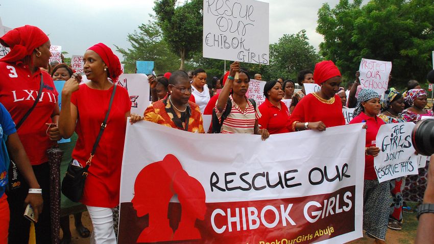 Former Nigerian Education Minister and Vice-President of the World Bank's Africa division (3r L) Obiageli leads a march of Nigeria women and mothers of the kidnapped girls of Chibok, calling for their freedom in Abuja on April 30, 2014. Nigerian protesters marched on parliament today to demand the government and military do more to rescue scores of schoolgirls kidnapped by Boko Haram Islamists more than two weeks ago. Dubbed "a million woman march" and promoted on Twitter under #BringBackOurGirls, the protest was not expected to draw a massive crowd and turn-out was hindered by heavy rain in the capital Abuja. But several hundred women and men, mostly dressed in red, marched through the rain towards the National Assembly carrying placards that read "Find Our Daughters."