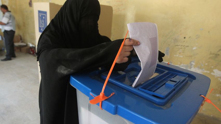 An Iraqi woman casts her vote at a polling station in Baghdad's Sadr City district during the country's general elections on April 30, 2014.