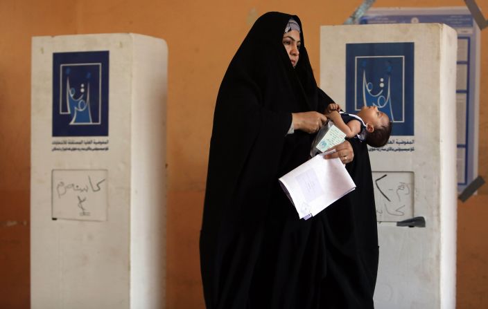 APRIL 30 - BASRA, IRAQ: A woman prepares to cast her vote for the parliamentary elections. <a href="http://cnn.com/2014/04/30/world/meast/iraq-elections/index.html">Iraq is holding its third poll</a> since the 2003 U.S.-led invasion that toppled dictator Saddam Hussein. 21.5 million voters are eligible to cast their ballots. More than 9,000 candidates are vying to fill 328 seats.