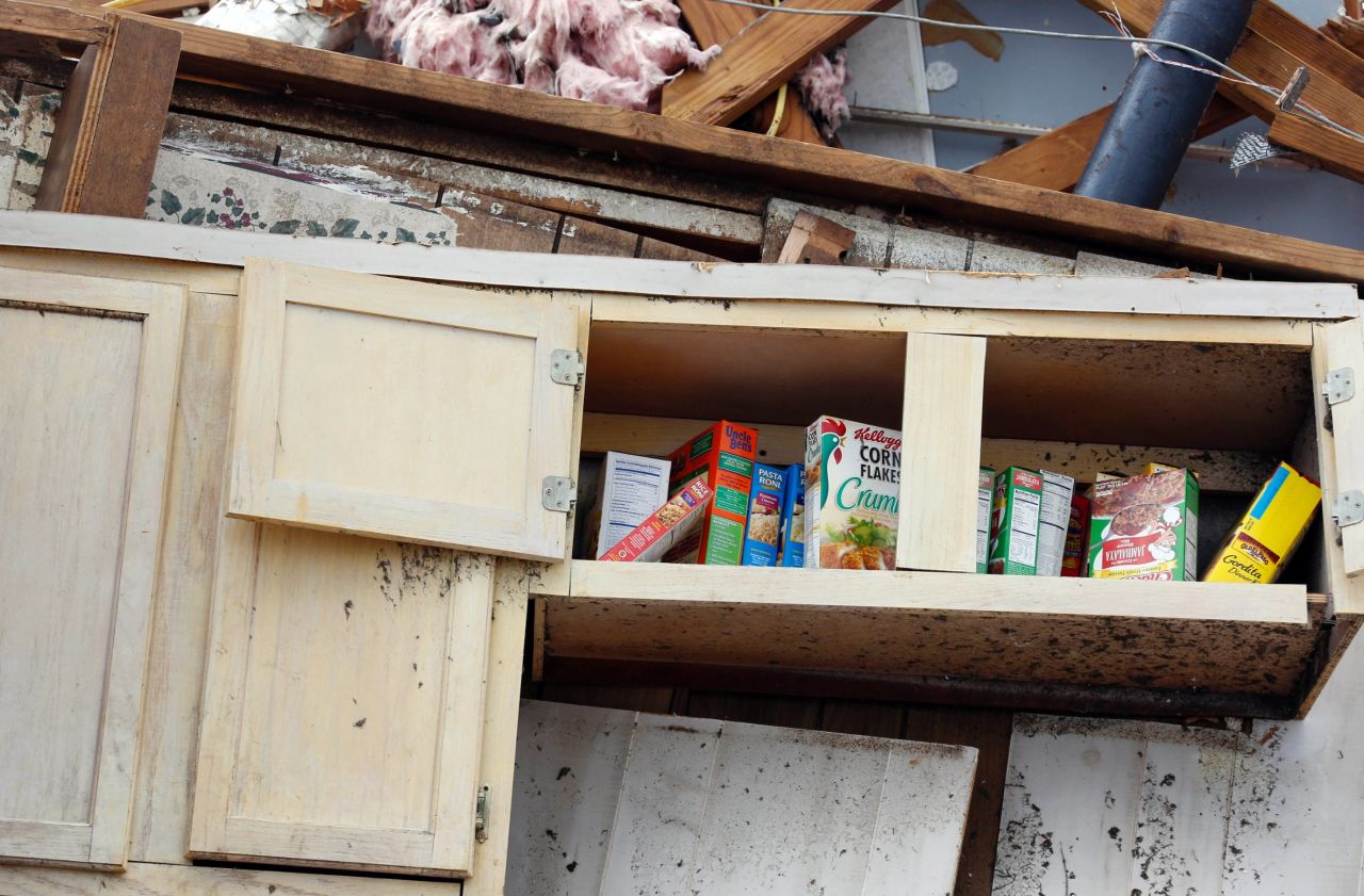 A kitchen shelf stands in what remains of a home in Louisville on April 29.