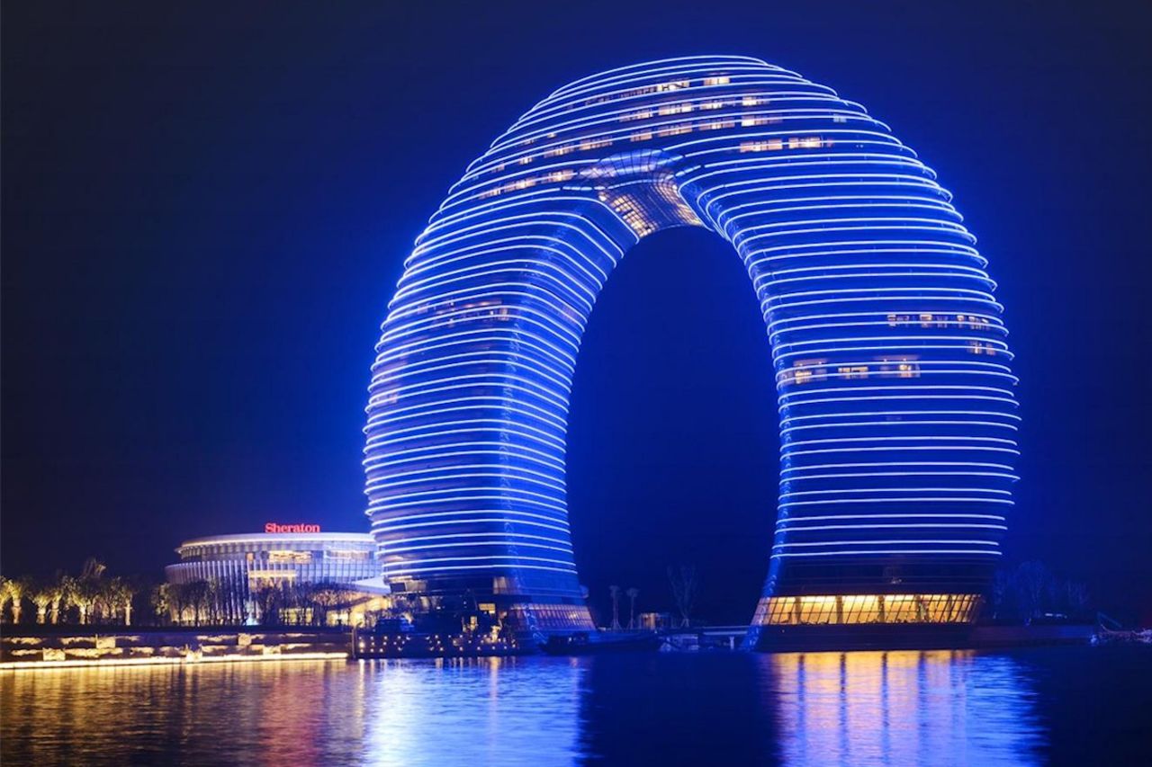 <strong>Sheraton Huzhou Hot Spring Resort, Huzhou</strong><br /><strong>Architect: </strong>MAD architects<br /><strong>Status: </strong>Opened in 2013<br /><strong>Rooms: </strong>321<br /><strong>Fast fact:</strong> Constructed of "layers" of floors to create a ring that rises from the south bank of Huzhou's Taihu Lake, this $1.5 billion Sheraton hotel received a lot of attention on its opening for its unusual design. The local region is known for its beautiful scenery, which includes hot springs and bamboo forests; scenes from Oscar-winning "Crouching Tiger, Hidden Dragon" were filmed in Huzhou. <br /><a href="http://www.starwoodhotels.com/sheraton/property/overview/index.html?propertyID=3414" target="_blank" target="_blank"><em>Sheraton Huzhou Hot Spring Resort</em></a><em>, No. 5858 Taihu Road, Huzhou, Zhejiang, China; +86 572 2299 999</em>