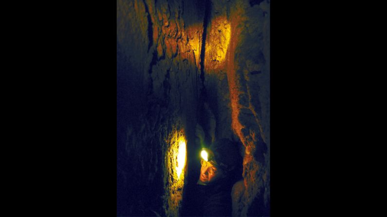 Glenwood Caverns co-owner Steve Beckley crawls through a crack while emerging from Beginner's Luck, a passage deep within Iron Mountain near Glenwood Springs, Colorado.