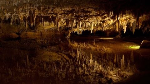 Stalactites, at top, reflect on underground pond water  at Luray Caverns in Luray, Virginia.