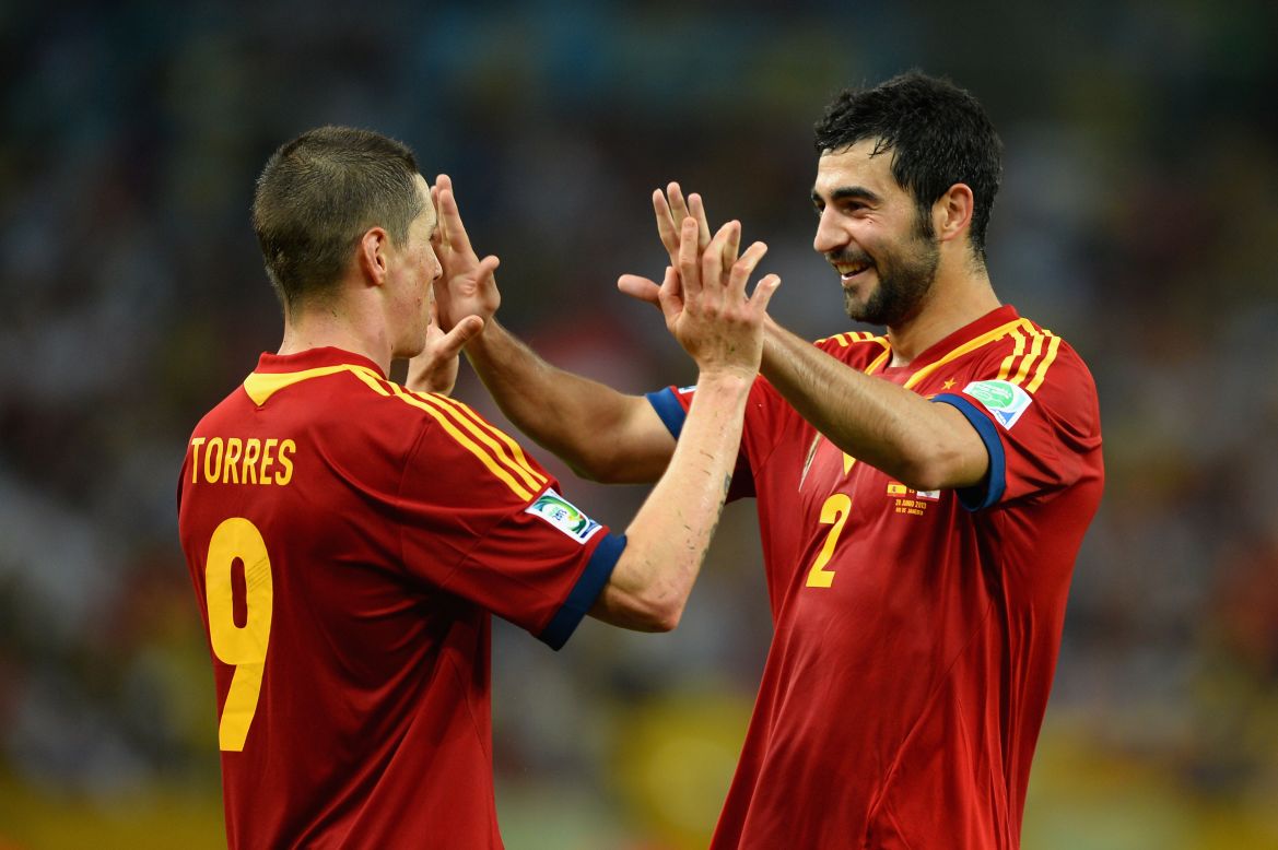 Torres celebrates with teammate Raul Albiol. David Villa also scored a hat-trick, David Silva netted twice and Juan Mata also got on the score sheet.
