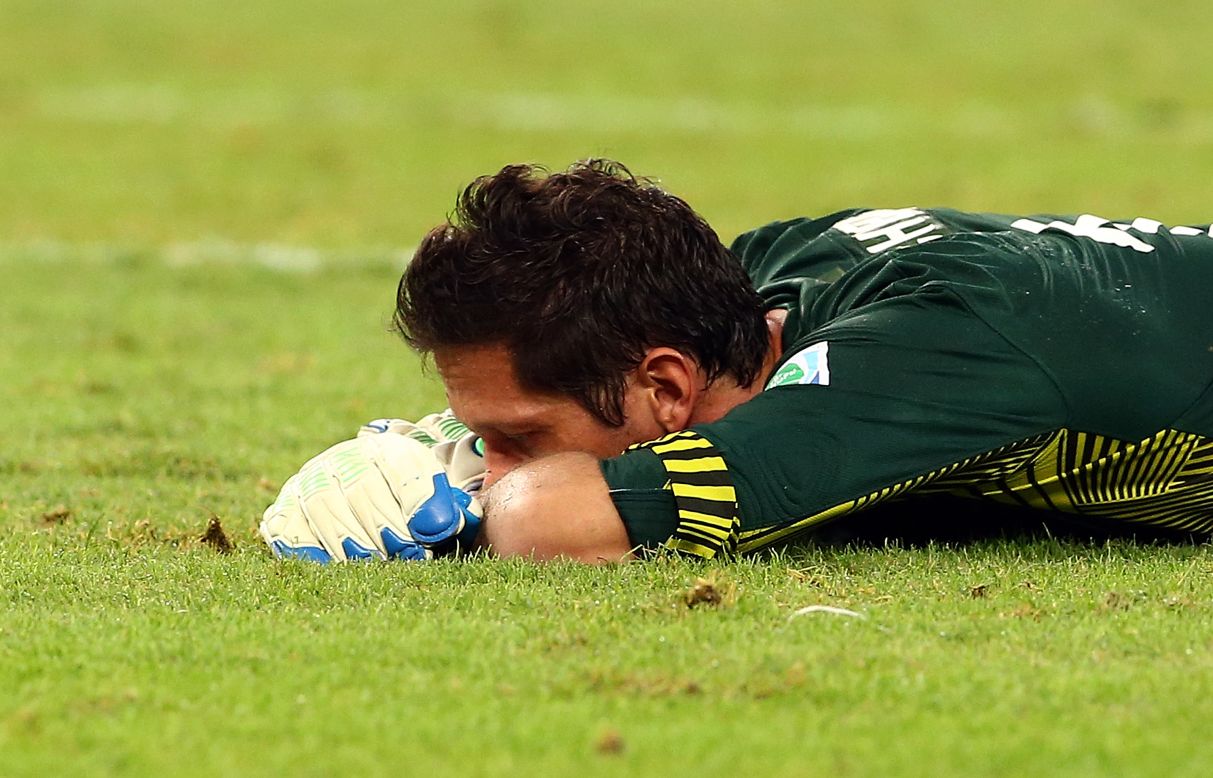Tahiti goalkeeper Mickael Roche buries his face in the Maracana turf. "I hate having goals scored against me, but 10? It really hurts," he said.  