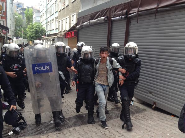 CNN's Ivan Watson says this picture shows one of at least half a dozen people detained by Turkish police in Istanbul's Besiktas neighborhood. "Some protesters have been throwing rocks and bottles and shooting fireworks at police, who respond with plastic pellets, water cannons and copious amounts of tear gas," he says.
