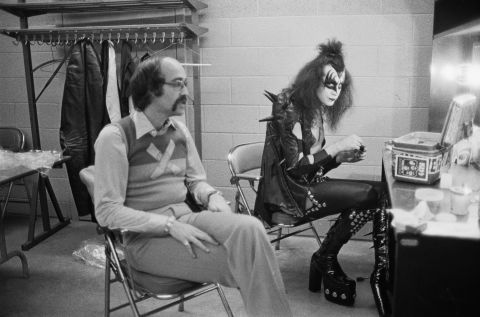 Gene Simmons, KISS' long-tongued bassist and vocalist, sits backstage in Detroit with Larry Harris in May 1975. Harris co-founded Casablanca Records, KISS' record label.