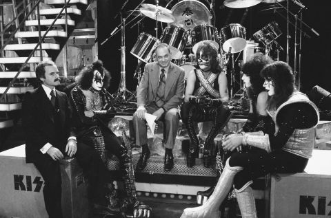 KISS' trip to the top was guided by manager Bill Aucoin, left, who sat down with the band for an NBC documentary, "Land of Hype & Glory," that aired in 1978. At center, with Peter Criss, is NBC's Edwin Newman.