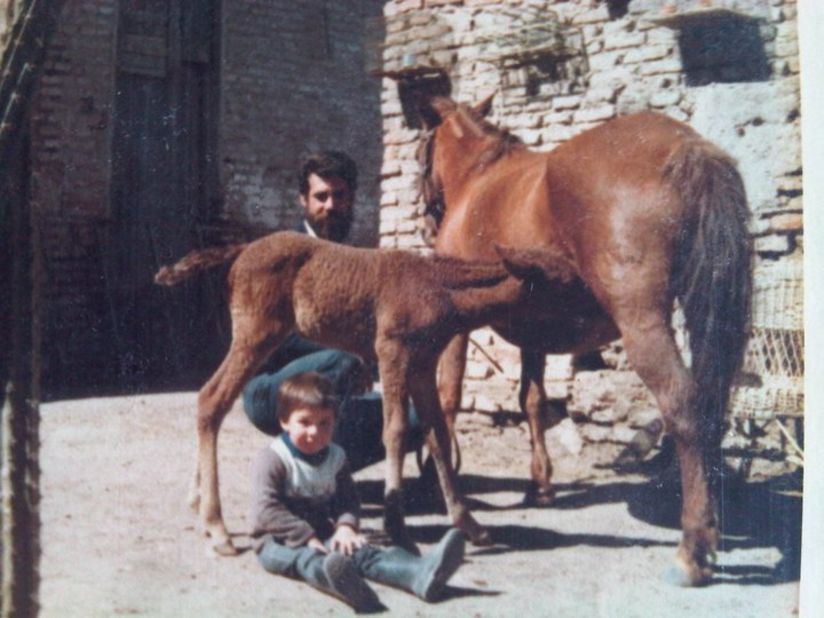 The school was founded by the Scarpati family. Here a young Cristobal and his father Oscar tend to two horses.