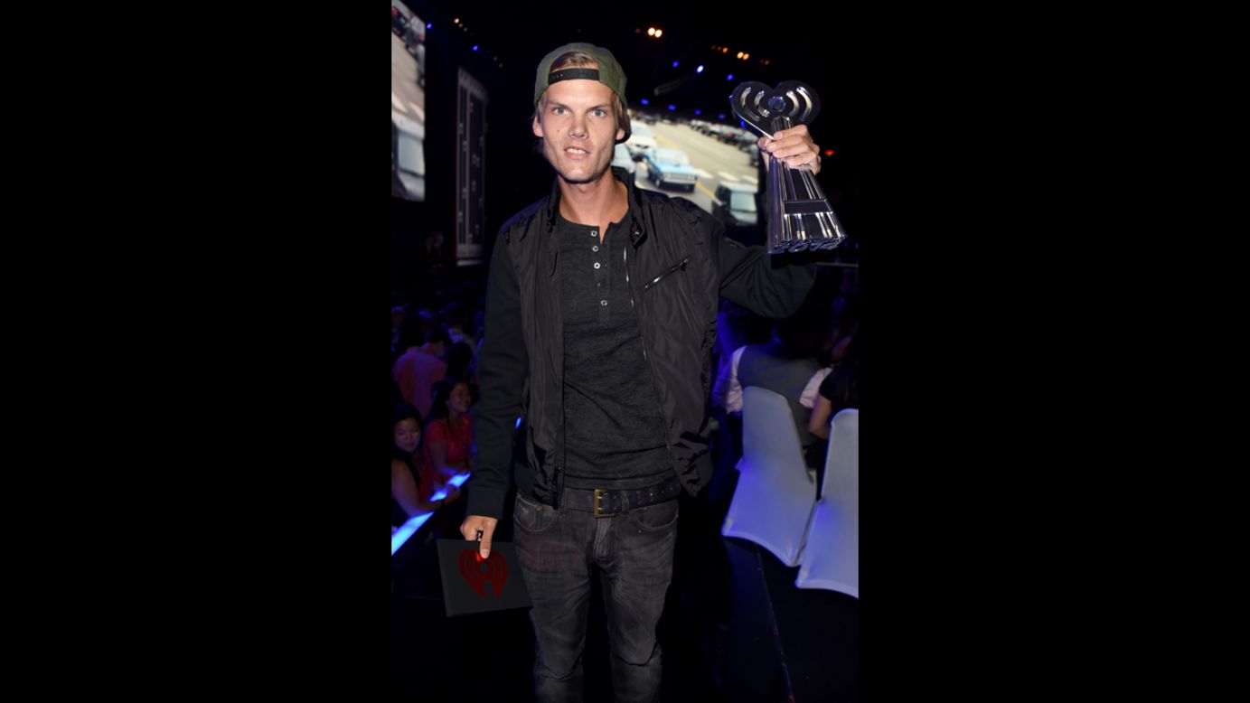  DJ Avicii shows off his award as he walks backstage.