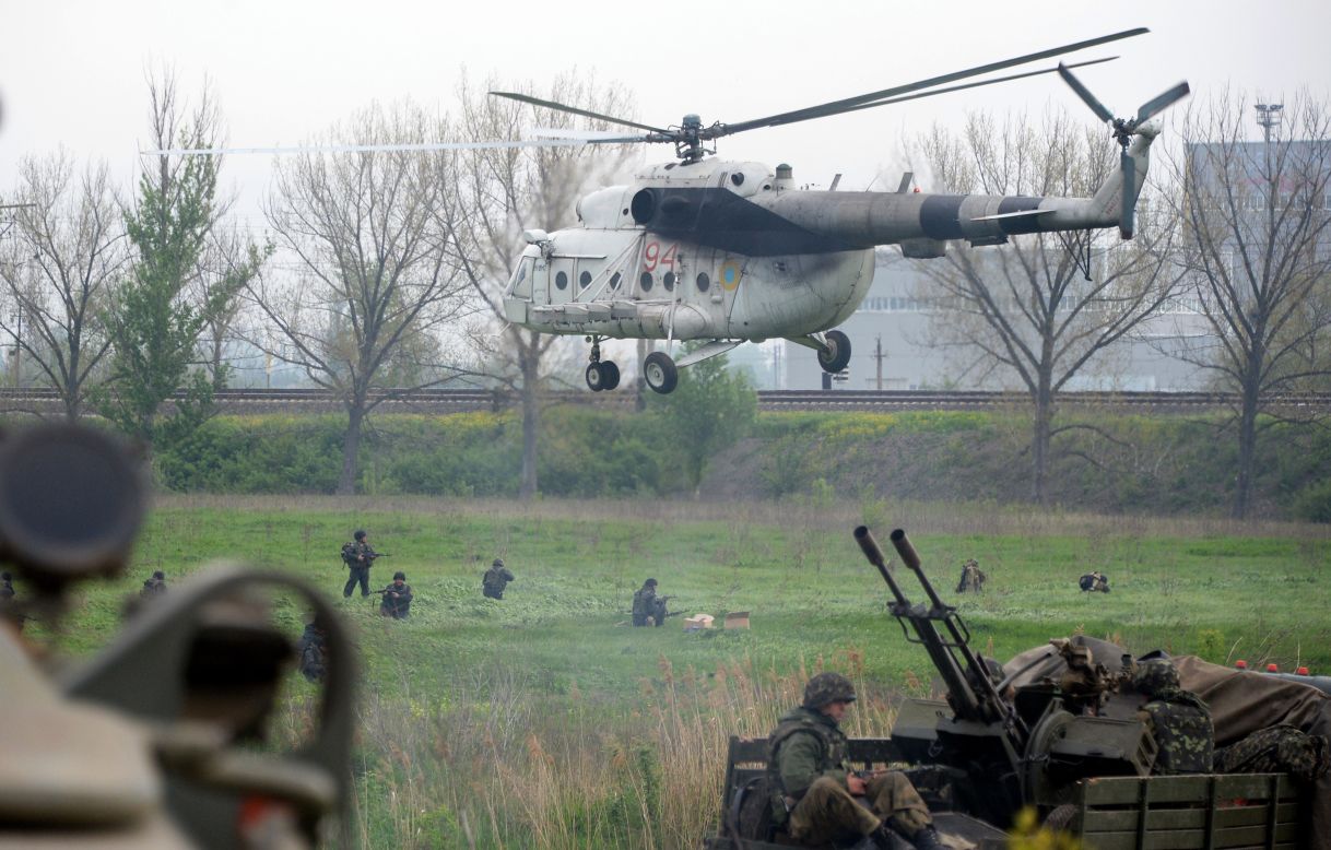 Ukrainian soldiers arrive to reinforce a checkpoint that troops seized Friday, May 2, in Andreevka, a village near Slovyansk. Two helicopters were downed Friday as Ukrainian security forces tried to dislodge pro-Russian separatists from Slovyansk, Ukraine's Defense Ministry said.