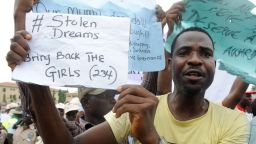 A man carries placard to campaign for the release of schoolgirls kidnapped by Boko Haram Islamists more than two weeks ago during worker's rally in Lagos on May 1, 2014.