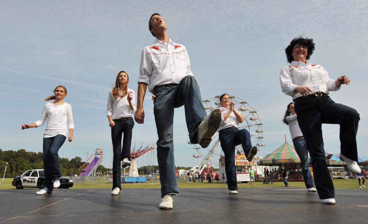 "Rocky Top" has become ingrained among thousands of Tennesseans, from the Smoky Mountains in the east to the western bluffs along the Mississippi River. Kelly Lovelace, 24, center, kicks it to the tune of "Rocky Top" with the Riverboat Cloggers during the 2012 Bartlett Festival and Car Show. 