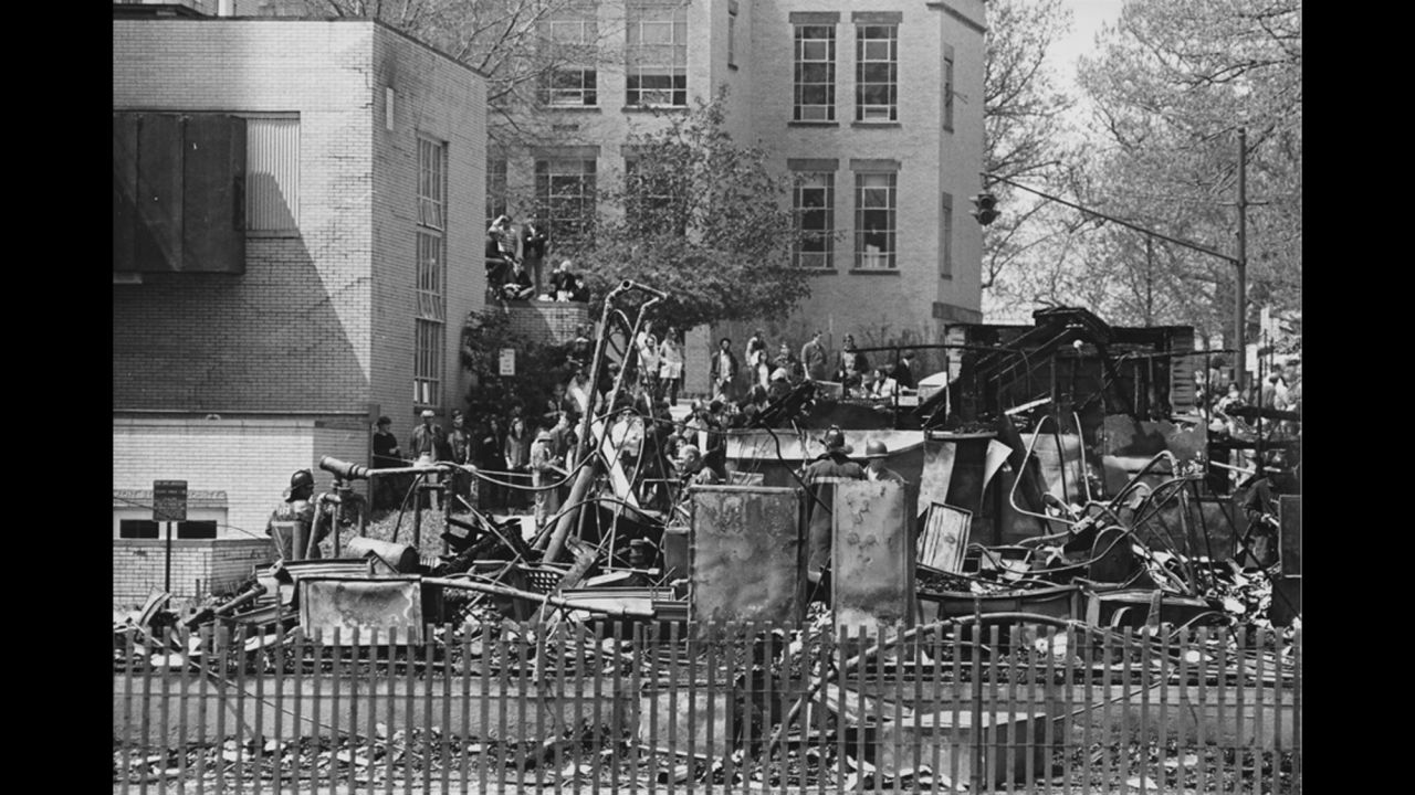 A night of violence in downtown Kent is followed by a student march to the campus ROTC building the next day. Some students try to burn the building down. While the protesters claim they left the building intact and in the hands of campus police when they returned to their dorms, the building is destroyed. It is still not clear who burned it down. 