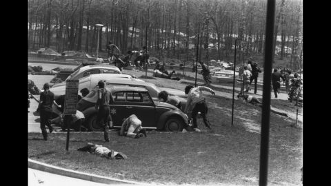 Students run for cover after the National Guard opens fire. Twenty-eight guardsmen fired into the crowd for 13 seconds, wounding nine students and killing 4.