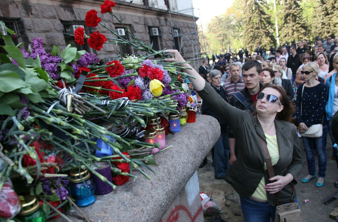 People lay flowers and candles at the burned trade union building in Odessa on May 3.
