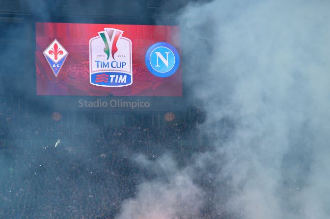 Smoke rises over Rome's Olympic Stadium before the Italian Cup Final. Napoli's ultras pelted the pitch with flares when news of the violence spread.