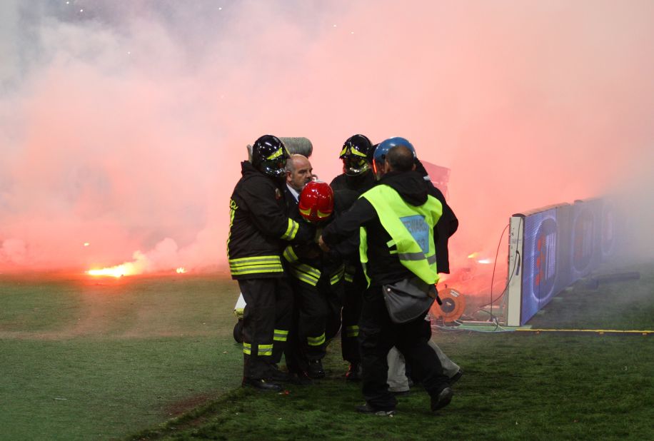 A firefighter is injured by a flare before the Italian Cup Final.