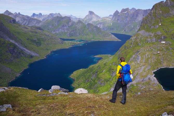 A hiker enjoys a sunny day on the Lofoten islands in <strong>Norway</strong>, the second happiest country.  According to the research, Norway ranks above average in all of the 11 dimensions that the OECD considers as "essential to a good life."