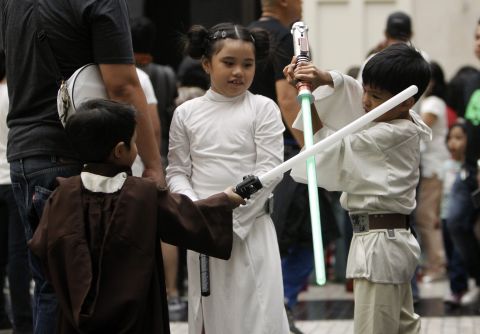 Children wearing "Star Wars" costumes play with their light sabers inside a mall in Pasay City, Philippines.
