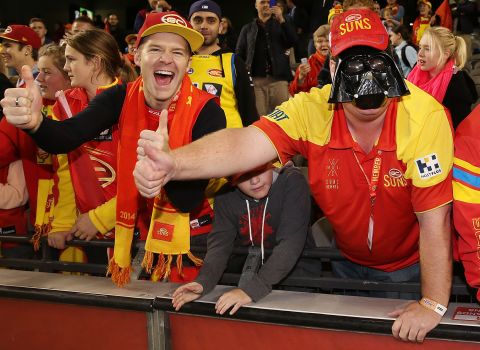 A Gold Coast Suns fan with a Darth Vader mask celebrates the team's win during the round seven Australian Football League match against the North Melbourne Kangaroos at Etihad Stadium in Melbourne. 
