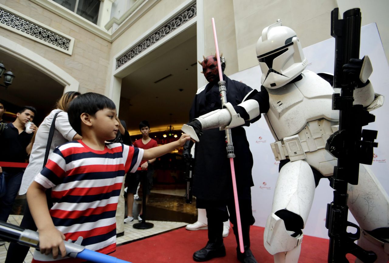 A child fist-bumps a Stormtrooper during "Star Wars Day" celebrations at Pasay City, Philippines.