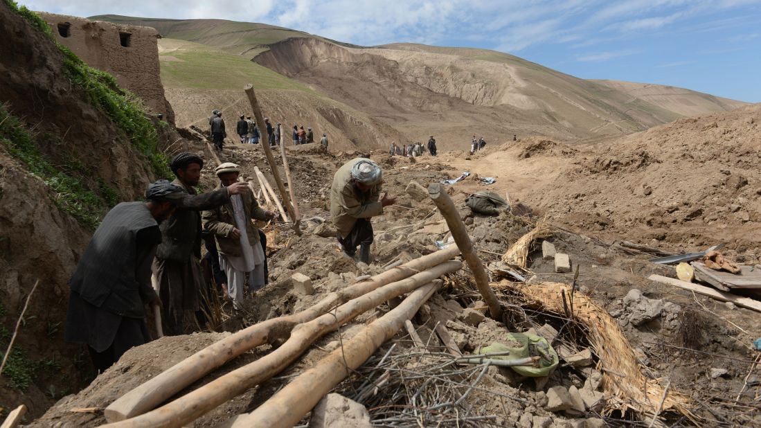 Villagers search through debris on May 5.