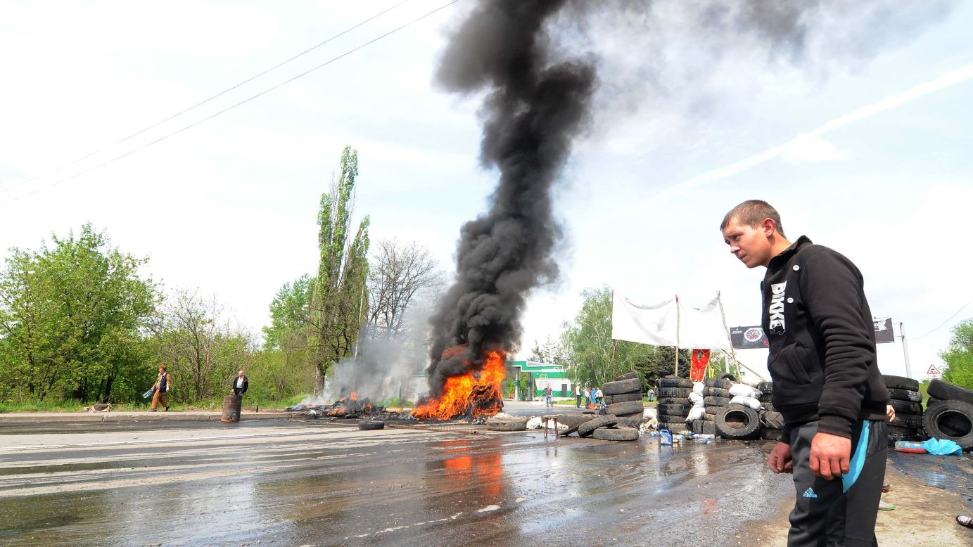 A man walks past burning tires near Kramatorsk on May 3.