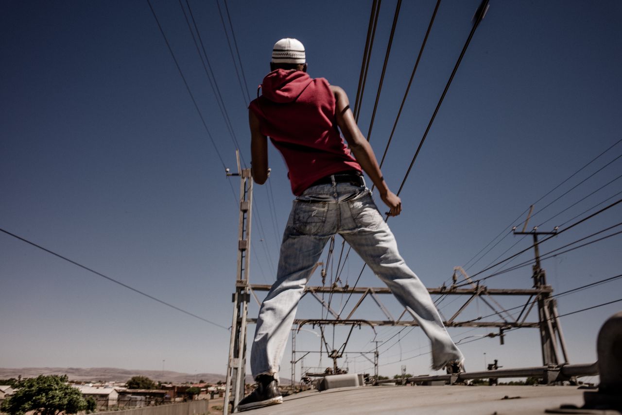 Italian photographer Marco Casino spent a month capturing "staff riders," or train surfers, in Katlehong, a South African township near Johannesburg.