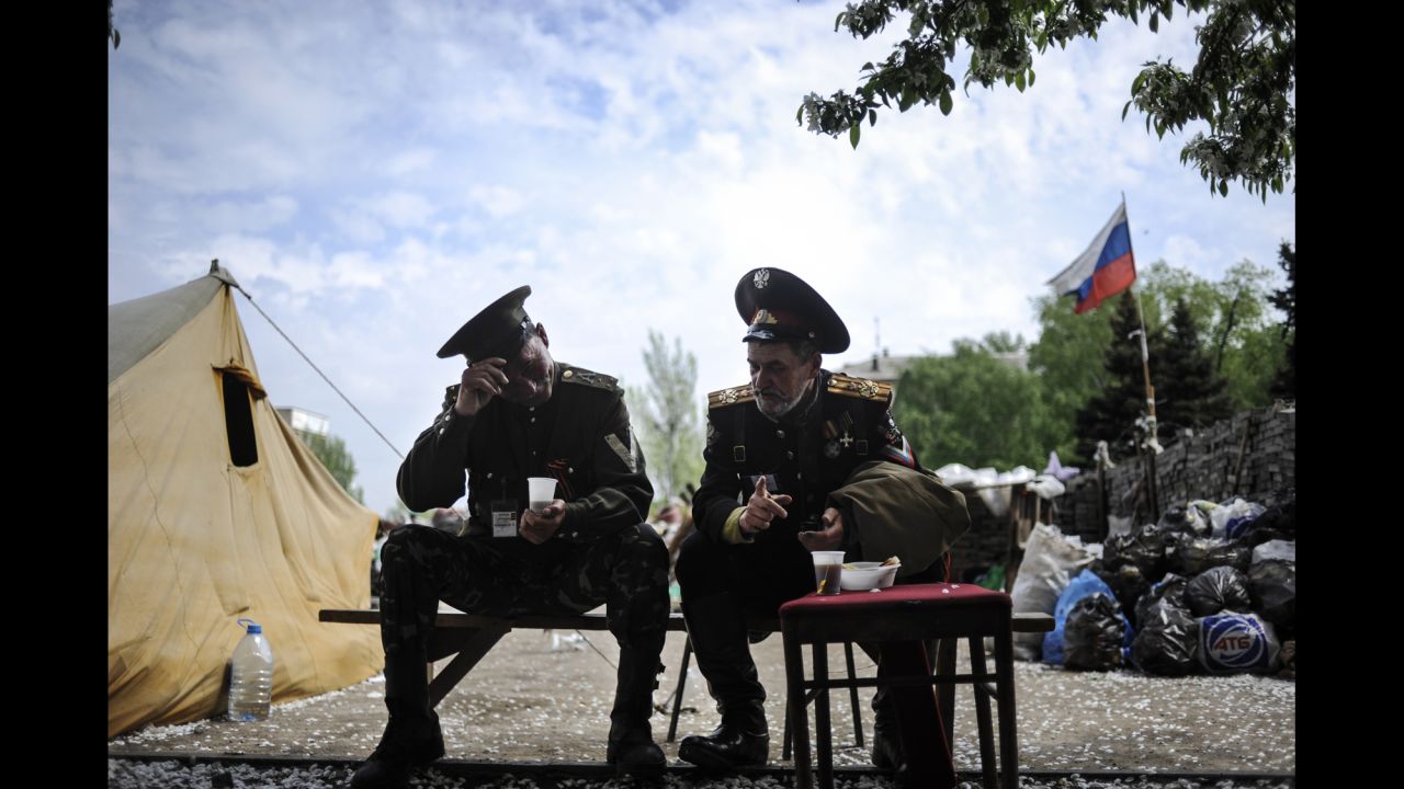 Pro-Russian Cossacks sit outside the regional administration building in Donetsk on May 5.