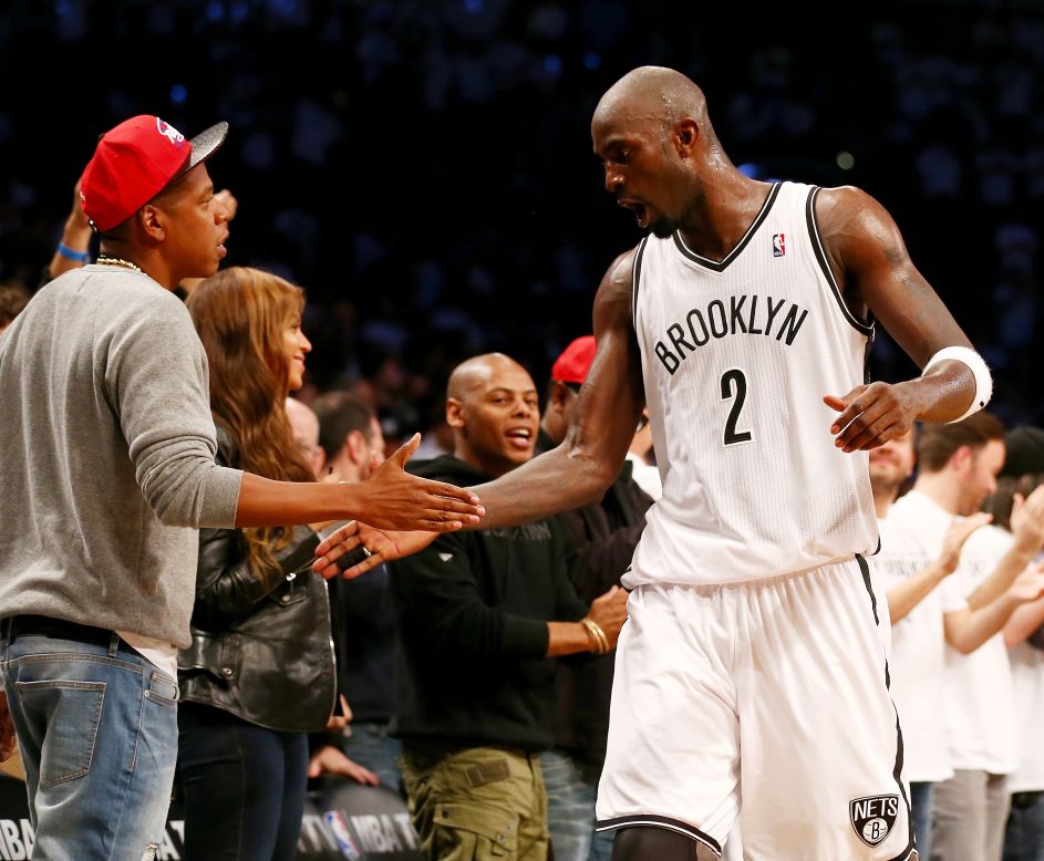 Kevin Garnett of the NBA's Brooklyn Nets is congratulated by rapper Jay-Z during Brooklyn's Game 6 playoff victory against Toronto on Friday, May 2. Brooklyn went on to win Game 7 in Toronto and advance to the Eastern Conference semifinals. 