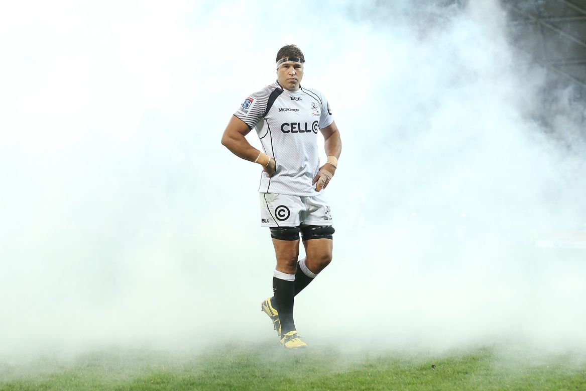 Thick smoke from a machine trails rugby player Willem Alberts at a Super Rugby match in Melbourne on Friday, May 2. Alberts' team, the Natal Sharks, defeated the Melbourne Rebels 22-16.
