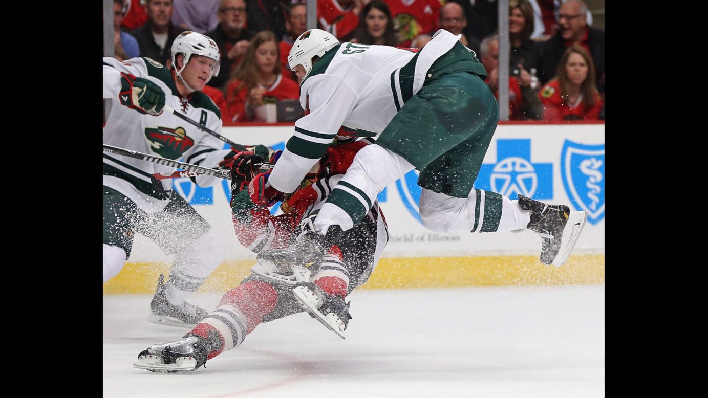 Clayton Stoner of the Minnesota Wild, right, knocks down Ben Smith of the Chicago Blackhawks on Sunday, May 4, in Game 2 of their NHL playoff series. Chicago won the home game 4-1 to take a 2-0 lead in the best-of-seven series.
